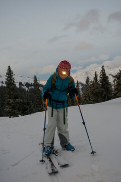 Young girl putting on skis, Red Mountain Pass, San Juan National Forest, Silverton, Colorado, USA