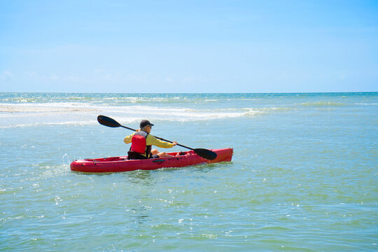 Woman kayaking in a calm ocean