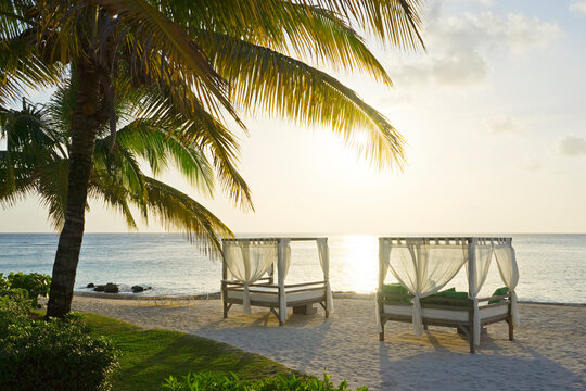 Beds on beach at sunset, San Miguel&Acirc;&nbsp;de&Acirc;&nbsp;Cozumel,&Acirc;&nbsp;Quintana&Acirc;&nbsp;Roo, Mexico