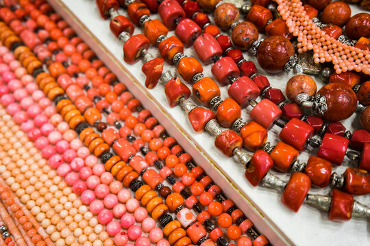 Red beaded necklaces for sale at a bazaar in Madaba, Jordan.