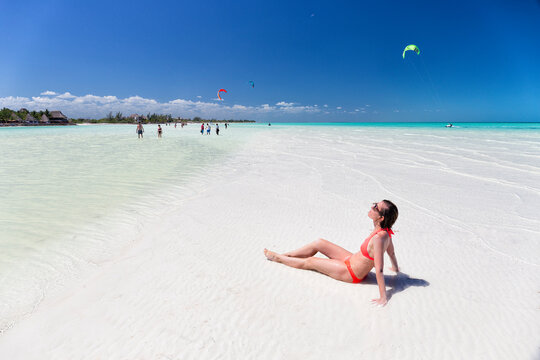 Tourists sunbathing on idyllic beach in Holbox