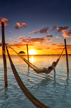Woman in hammock at sunset, Holbox Island, Cancun, Yucatan, Mexico