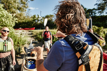 Sea kayaking instructor demonstrating proper paddling hand position, Portland, Maine, USA