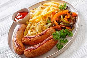 Grilled sausages, peppers, onion and french fries