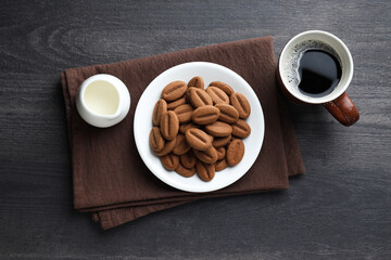 Concept of tasty snack for hot drink - cookies in the shape of coffee seeds