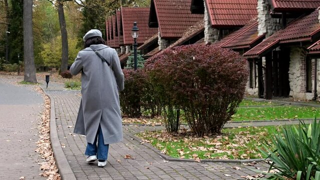 Autumn Season Woman In Grey Coat Walking By Neighborhood Sidewalk