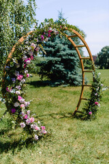 Fototapeta premium Arch with white flowers and greenery for wedding ceremony in the trend style. Beautiful wedding decoration. 