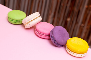 Sweet colorful macarons  on pink background. Tasty colourful macaroons. High quality photo