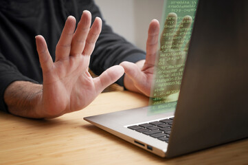 Hands recoil in stop gesture from the laptop computer, as unknown code appears on the screen, concept of cybercrime like hacking attack, ransomware and other online risks, copy space - obrazy, fototapety, plakaty