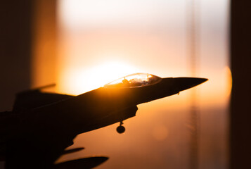 F-16 fighter against the background of the setting sun. Concept showing military support for Ukraine