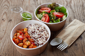 Rice with beans and vegetables, with vegetable salad, in a disposable dish