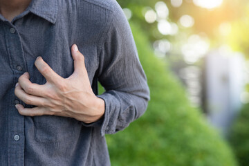
Close-up shot of man holding hands on chest, man having heart attack Chest pain, health care concept.