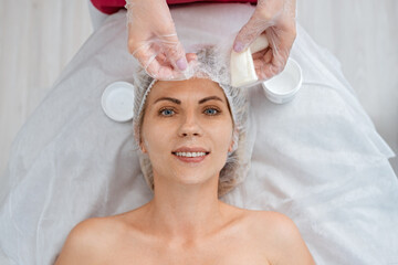 Cosmetologist applies silk threads for facelift. Non-surgical cosmetology. Skin care