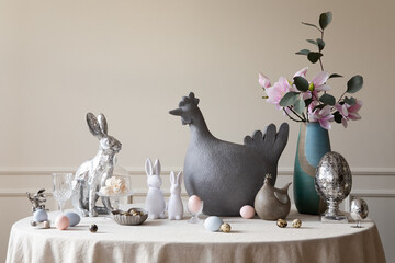 Spring composition of easter dining room interior with gray hen sculpture, easter bunny, colorful...