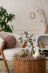 Creative composition of easter living room interior with boucle armchair, round pillow, vase with...