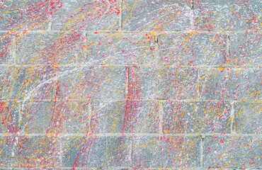 Concrete block wall background and texture.Colorful Concrete block wall as background,color painting on concrete  block  wall .Dropping acrylic paint on the concrete wall.Street art - graffiti.