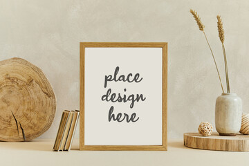 Creative composition of cozy minimalistic interior design with mock up poster frame, natural materials as wood and marbel, dry plants and personal accessories. Neutral beige colors, template.