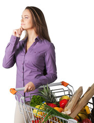 Portrait of a Woman with a Shopping Cart Full of Groceries Choosing a Product