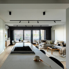 Modern composition of kitchen space with design kitchen island, black hookers, grey table, flowers, furnitures, big window and elegant personal accessories. Stylish home decor. Template.