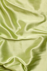 Smooth elegant light green silk or satin luxury fabric texture Top view