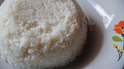 Cooked rice. Close up of white rice on a plate.