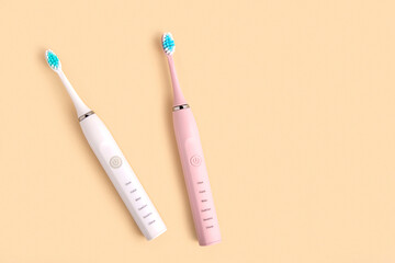 Electric Toothbrush. Top View, Flat Lay, Copy Space. Dental Care Supplies on Beige Pastel Studio Background. Oral Hygiene, Gum Health, Healthy Teeth. Modern Dental Ultrasonic Vibration Tooth Brush Set