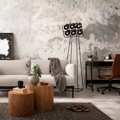 The stylish compostion at concrete living room interior with design gray sofa, wooden coffee table,...