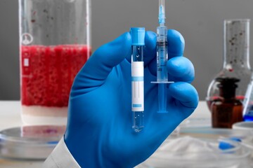 Hand with blood test tube for sample