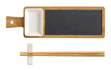 Bamboo sushi serving set cutout. Wooden board with black slate tray, porcelain soy sauce dish and pair of chopsticks on a rest isolated on a white background. East Asian tableware.