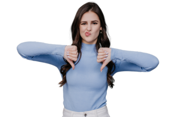 Beautiful European brunette in a lilac sweater and white pants, shows her thumbs down, wrinkled her face, looks at camera on transparent background. Bad decision. Mockup, decline, refuse. Against