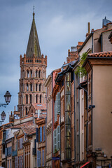 View on Saint Sernin Basilica bell tower from a street in Toulouse old town (South of France)