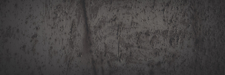 Old rusted metal texture. Rusty iron wall. Rough faded metal surface with spots, noise and grain. Dark wide panoramic background for grunge design. Shaded vintage texture with vignette.