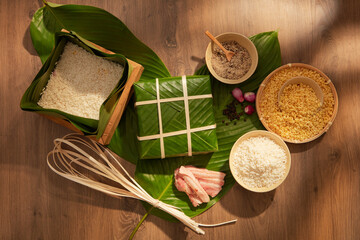 Sticky rice cake (Banh chung) and ingredients make its on wood background. for holiday food advertising, top view, flat lay.