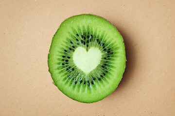 Heart shaped kiwi on recycled paper background - Kiwi is good for heart health - 574229322