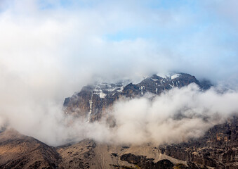 Spectacular View of Mountain Peak Piercing Through Clouds