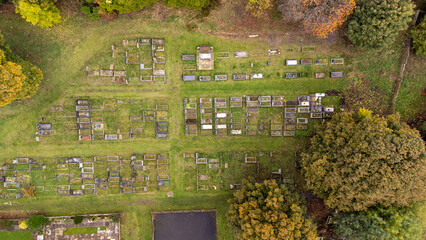 Aerial photo of the the town of Woodthorpe, it's a suburb in the south west of the city of York, North Yorkshire, England showing an aerial view of a grave yard cemetery in the autumn time.
