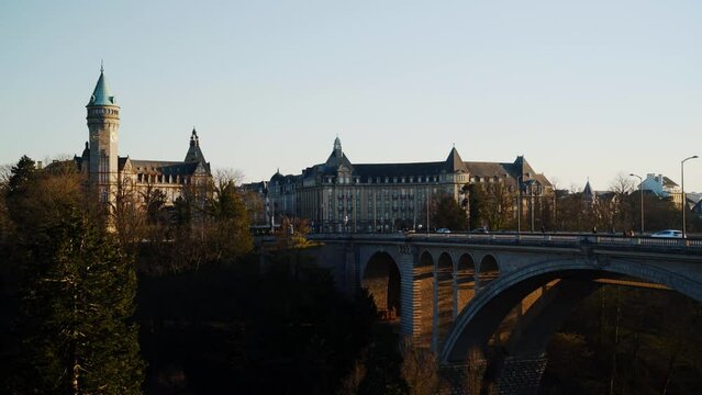 Luxembourg Adolf Bridge and city skyline, spuerkees tower airplane. 4k 24fps. Tripod. 