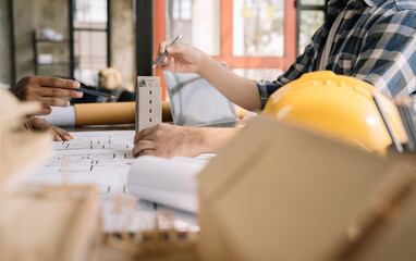 Engineer teams hands making model house. Engineer teams working in the office.