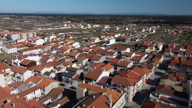 Aerial flyover village of Praia de Mira with red rooftops during sunny day with blue sky in Portugal,Europe