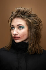 Fototapeta premium portrait of woman with smudged lipstick and in black jacket on beige background.