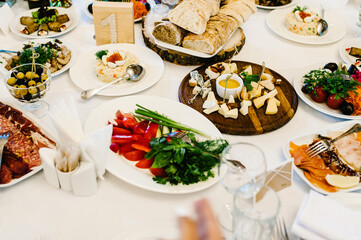 Festive table. Different festive dishes on rustic table. Side view.