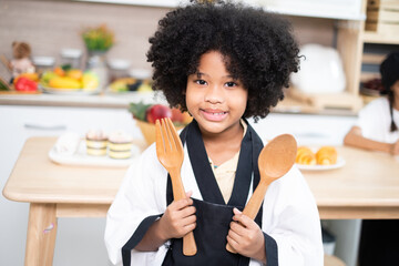 Adorable girls enjoy making baked goods in pastry and bakery class at culinary school.