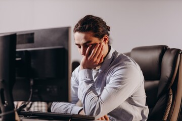 Young programmer has a problem. Software developer working on difficult task. Tired office worker...