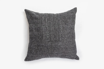 Black decorative pillow with geometric pattern isolated on a white background.
