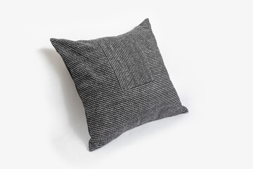 Black decorative pillow with geometric pattern isolated on a white background.
