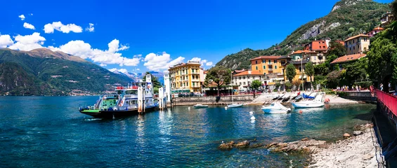 Poster One of the most beautiful lakes of Italy - Lago di Como. panoramic view of beautiful Varenna village, popular tourist attraction © Freesurf