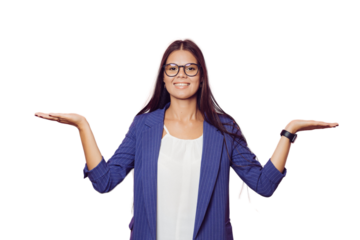 Young brunette in glasses dressed in a dark blue jacket and white blouse, with happy surprise spreads her hands, smiling wide, over transparent background. Shopping and lifestyle concept.