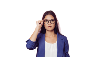 Young brunette in glasses dressed in a dark blue jacket and white blouse, adjusts her glasses, looking seriously, over transparent background with copy space. Smart people concept.