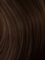 Natural brunette wig close-up. Hair texture. Hair dye, salon care, home coloring. 