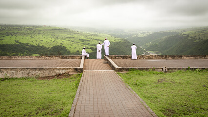 Omani Men Overlooking a vista in Wadi Darbat Park during Khareef
